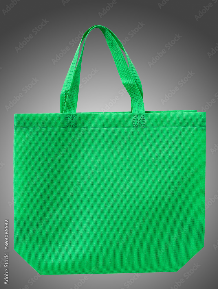 green cloth shopping bag isolated on black and white guardian background