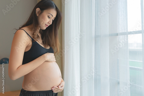Portrait of asian pregnant woman in the bedroom,Happy mother day concept