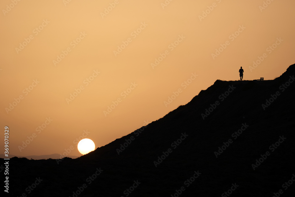 silhouette of a man on a mountain top during the sunset in Cabo de Gata, Almeria
