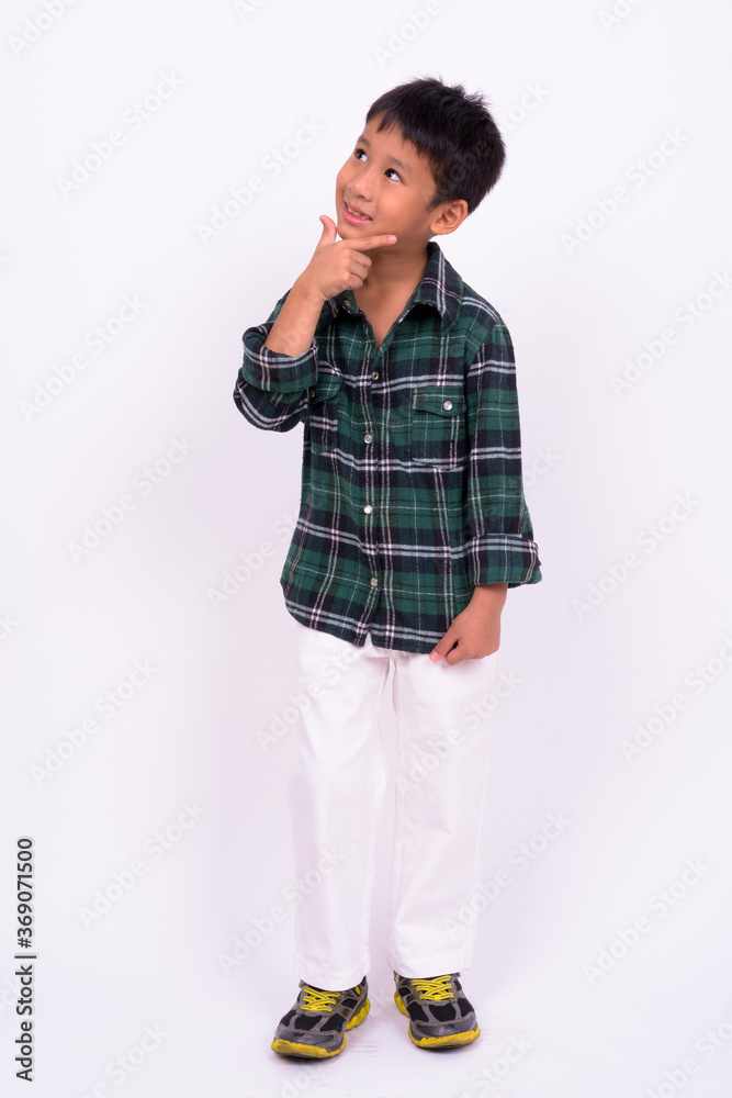 Studio shot of cute Asian boy against white background Studio shot of cute Asian boy against white background