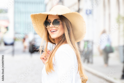 Happy woman on vacation wearing summer hat
