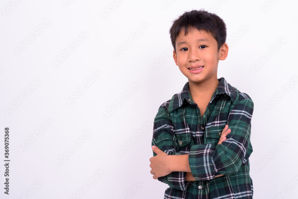 Studio shot of cute Asian boy against white background Studio shot of cute Asian boy against white background