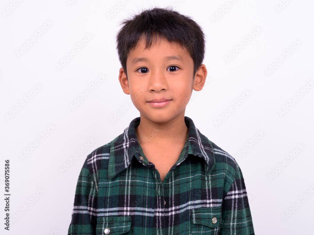 Studio shot of cute Asian boy against white background Studio shot of cute Asian boy against white background