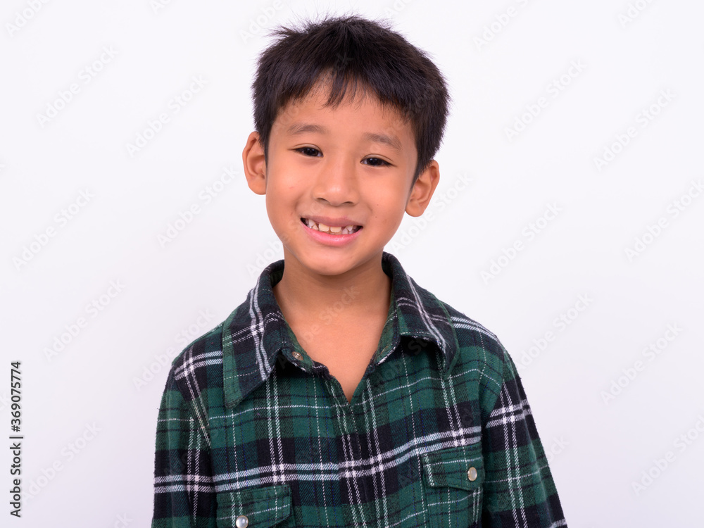 Studio shot of cute Asian boy against white background Studio shot of cute Asian boy against white background