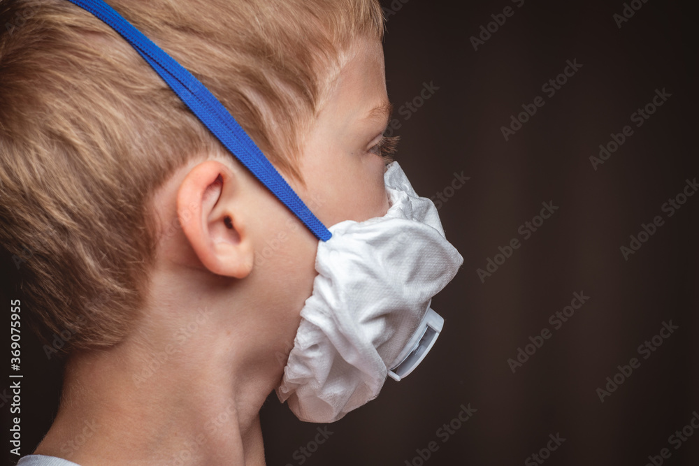 child in protective respirator with filter. protecting children from the virus