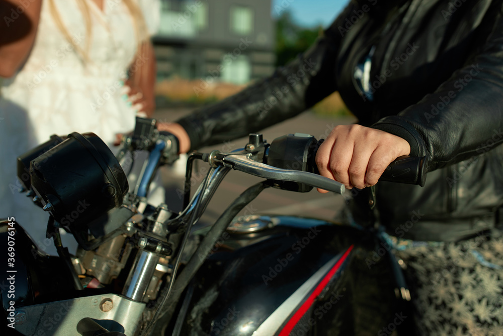 Two girl friends stay near motorbike. Sell motorcycle concept in the city. Fast delivery in covid time in town. Two girl friends stay near motorbike. Sell motorcycle concept in the city. Fast delivery in covid time in town.