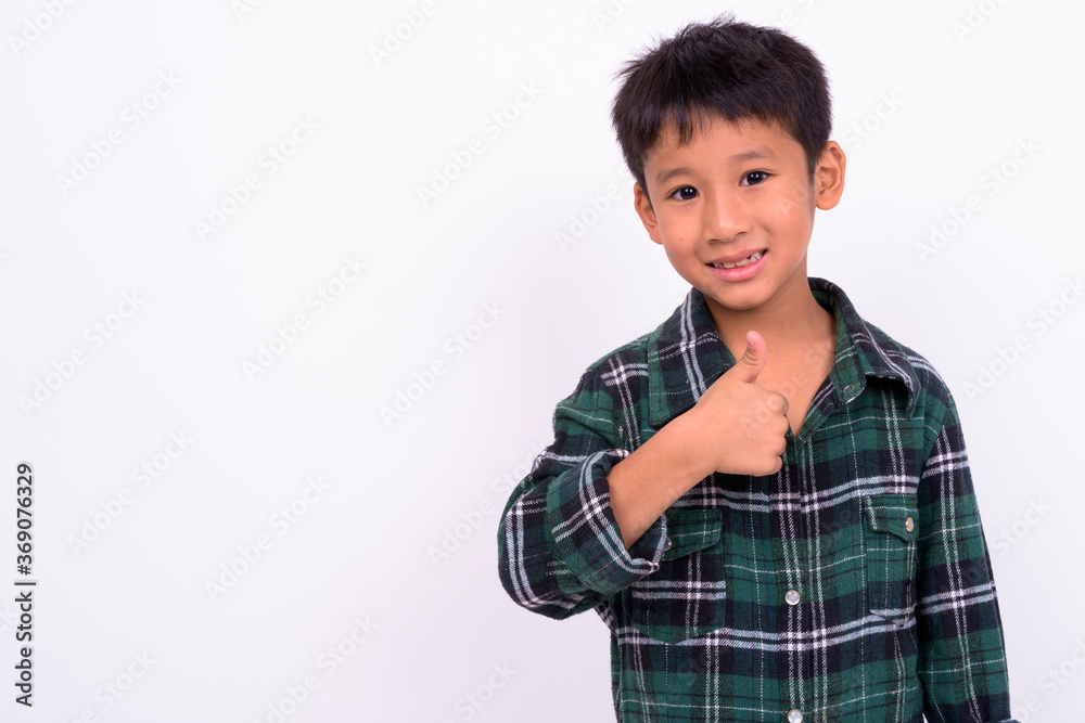 Studio shot of cute Asian boy against white background Studio shot of cute Asian boy against white background