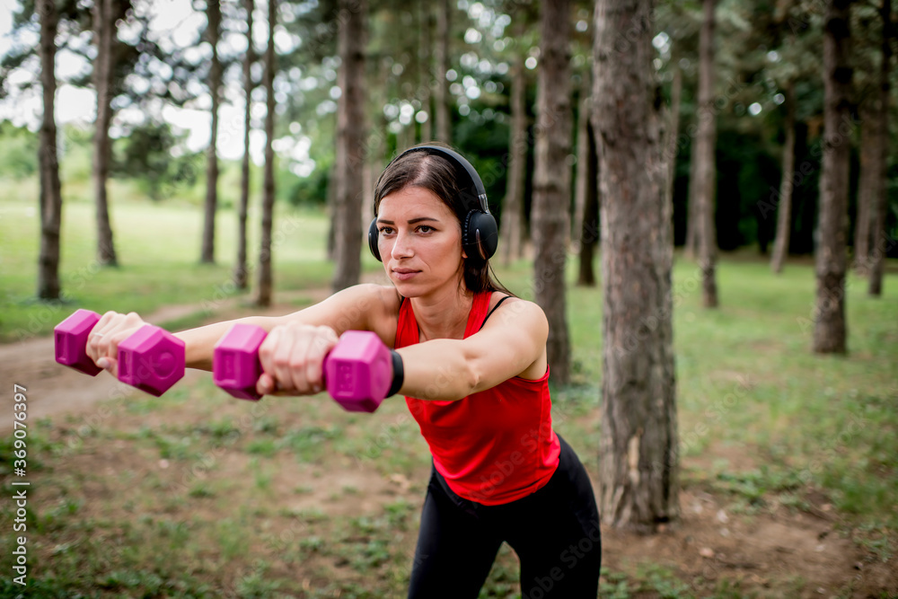 Young woman working out with a dumbbells Young woman working out with a dumbbells