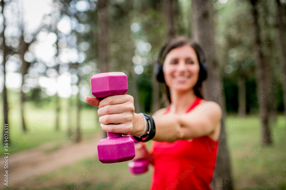Young woman working out with a dumbbells Young woman working out with a dumbbells