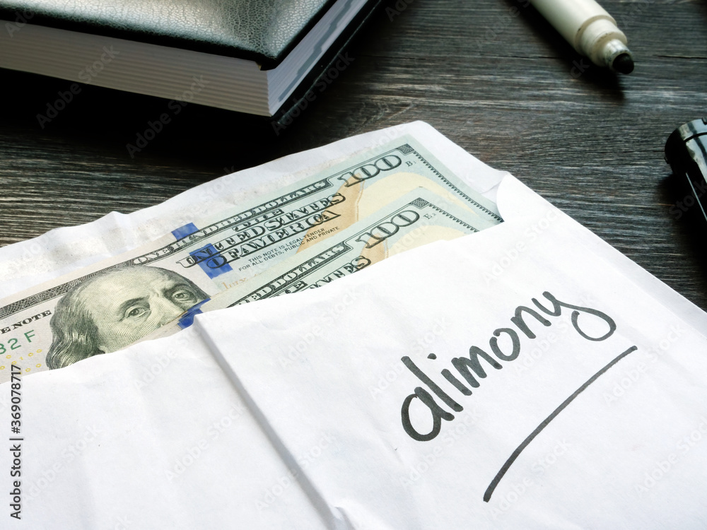 Alimony concept. Open envelope with cash on the desk. Alimony concept. Open envelope with cash on the desk.