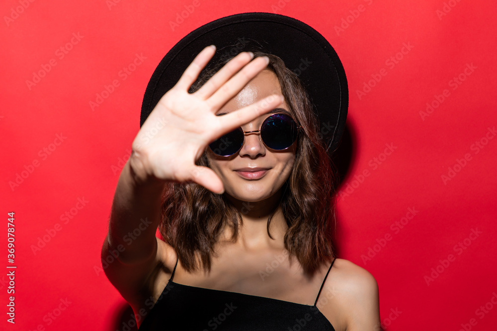 Young beautiful woman doing stop sing with palm of the hand over red background. Warning expression with negative and serious gesture on the face. Young beautiful woman doing stop sing with palm of the hand over red background. Warning expression with negative and serious gesture on the face.