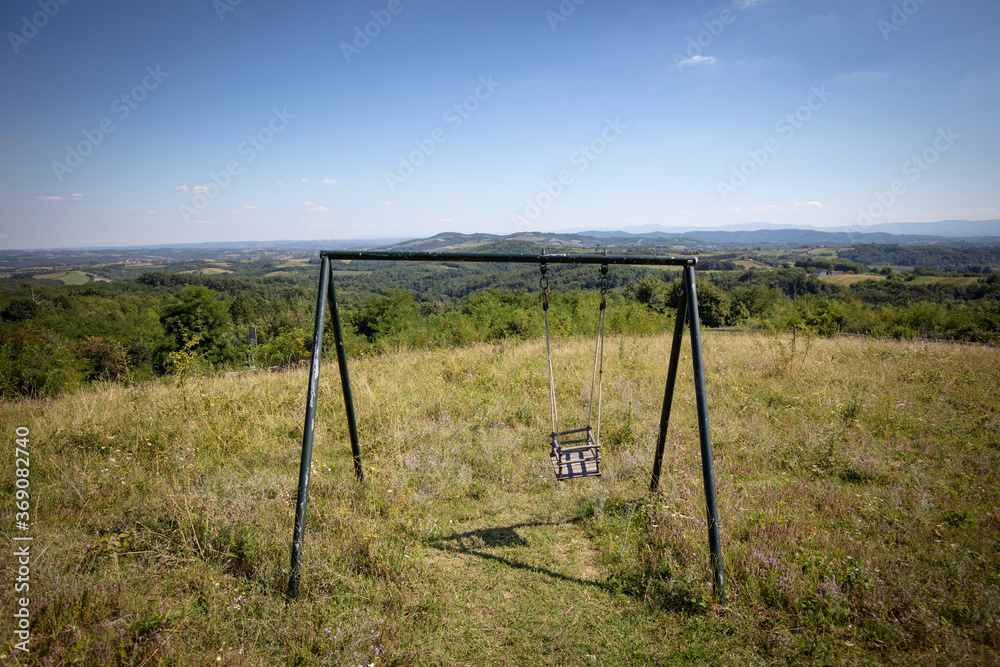 landscape in the mountains and the swing on the field in the rural Serbia, on the mountain Cer