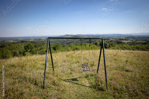 Obraz na płótnie landscape in the mountains and the swing on the field in the rural Serbia, on the mountain Cer w salonie