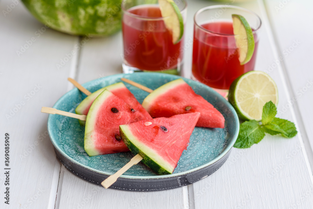 Fresh delicious watermelon sliced with mint and watermelon juice Fresh delicious watermelon sliced with mint and watermelon juice