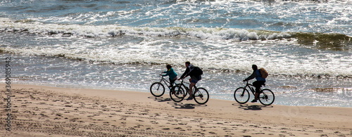 With bicycles on the beach