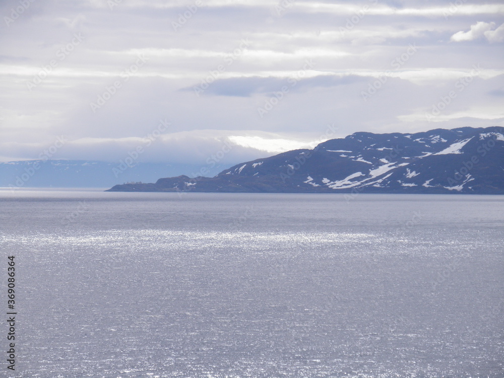 snow covered mountains in the sea, Norway