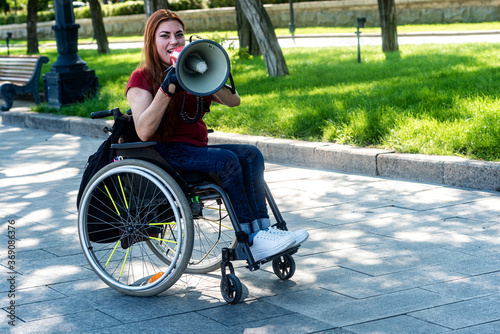 Disabled girl with a megaphone in her hand