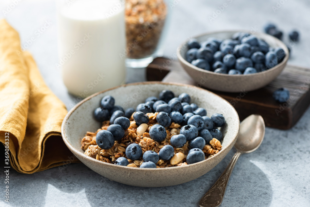 Bowl of granola with blueberries and bottle of milk. Healthy breakfast food Bowl of granola with blueberries and bottle of milk. Healthy breakfast food
