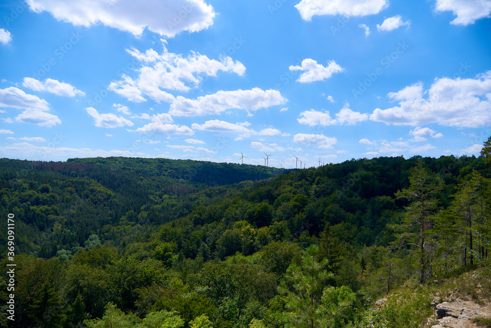 mountain landscape with blue sky and wind generators