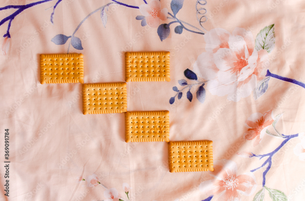 Multiple biscuits on pink floral background texture Multiple biscuits on pink floral background texture