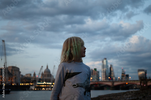 Profile of child with London skyline behind her. photo