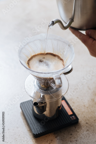 Person making coffee by pourover photo