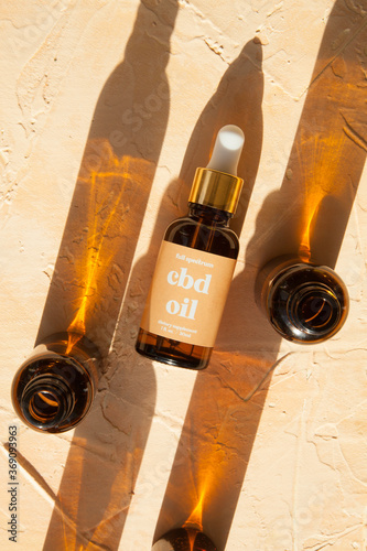 CBD oil bottles and droppers in sunlight