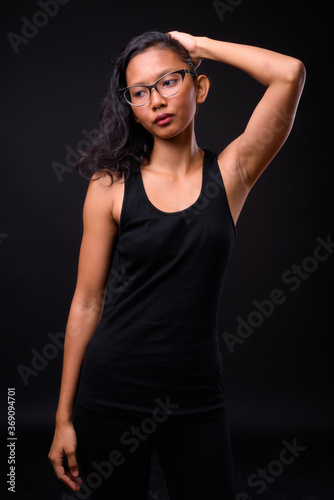 Portrait of young beautiful Asian woman with eyeglasses