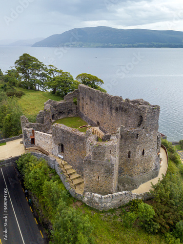Aerial shot of King John's castle in Carlinford with Irish sea and mountains in the background. Co. Louth, Ireland. July 2020