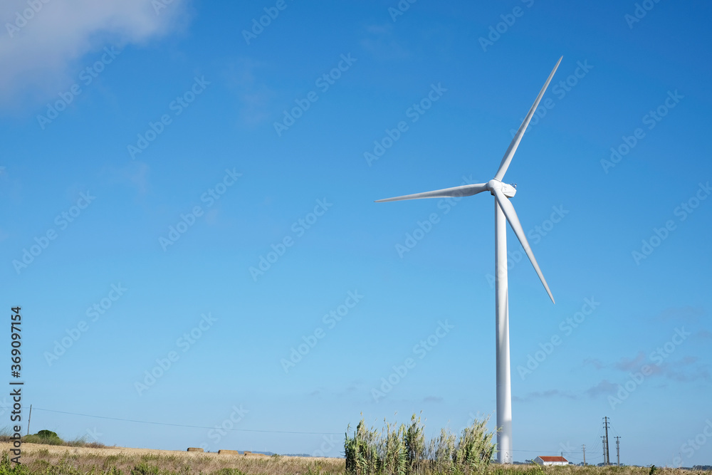 Windmill isolated generating electricity in sunny Portugal