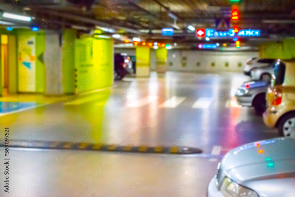 Parking car blurred. Empty road asphalt background in soft focus. Car lot parking space in underground city garage. Interior underground carpark.