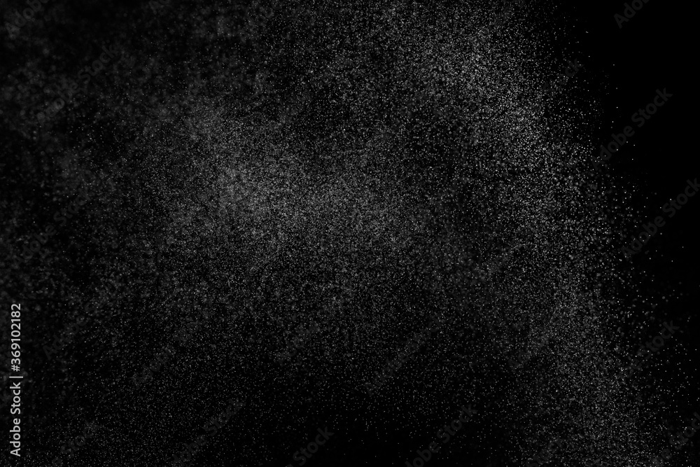 Abstract splashes of water on black background. Freeze motion of white particles. Rain, snow overlay texture. Abstract splashes of water on black background. Freeze motion of white particles. Rain, snow overlay texture.