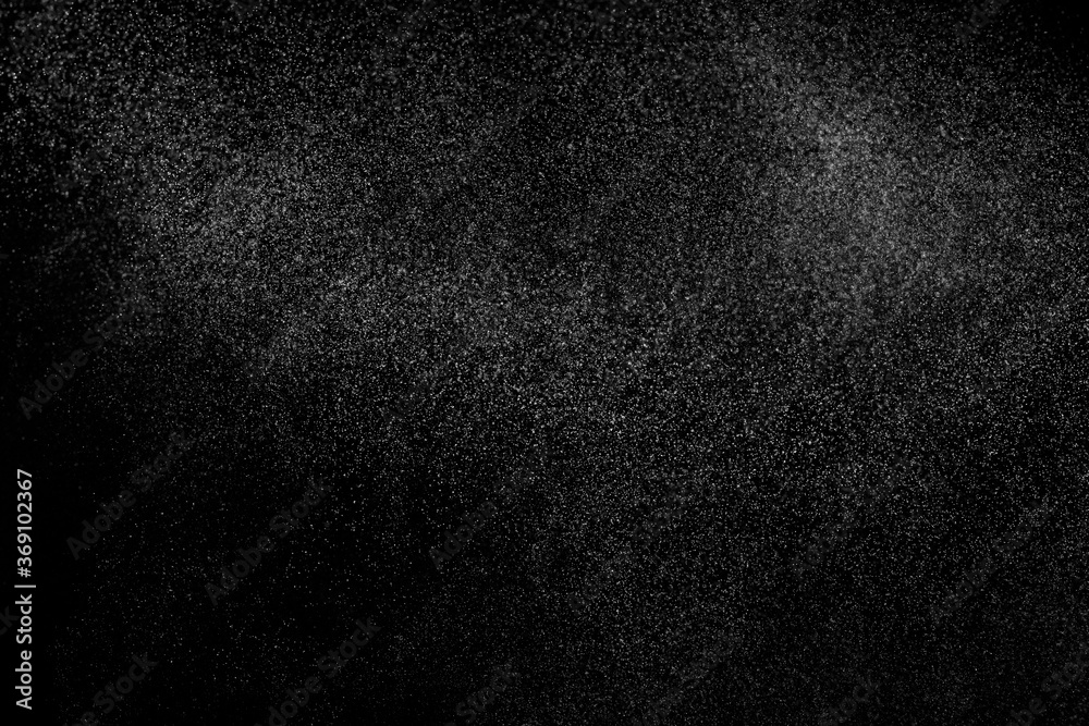 Abstract splashes of water on black background. Freeze motion of white particles. Rain, snow overlay texture. Abstract splashes of water on black background. Freeze motion of white particles. Rain, snow overlay texture.