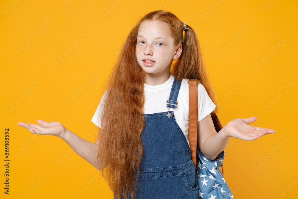 Young confused redhead school teen girl 12-13 years old in white t-shirt backpack spreading hands oops isolated on yellow background children studio portrait Childhood kids education lifestyle concept Young confused redhead school teen girl 12-13 years old in white t-shirt backpack spreading hands oops isolated on yellow background children studio portrait Childhood kids education lifestyle concept
