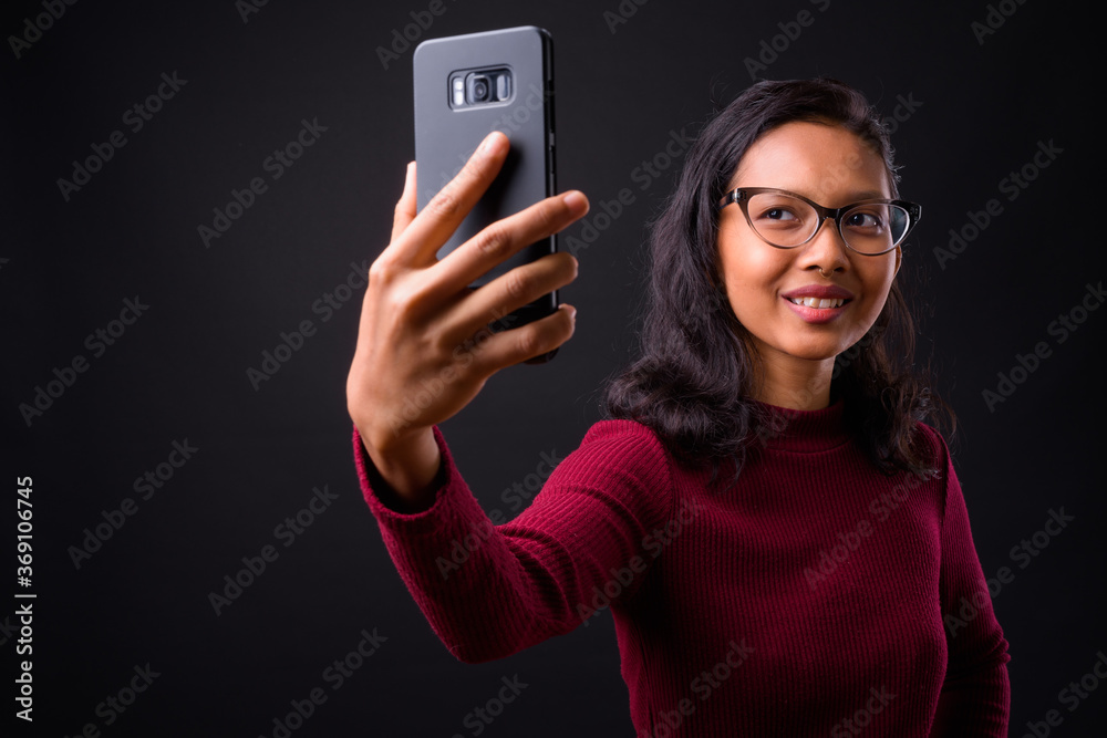 Portrait of happy young beautiful Asian businesswoman taking selfie Portrait of happy young beautiful Asian businesswoman taking selfie