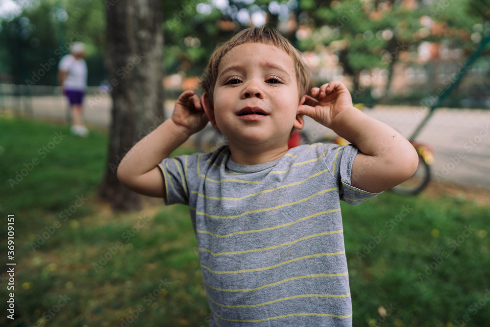 Funny boy fooling around in park