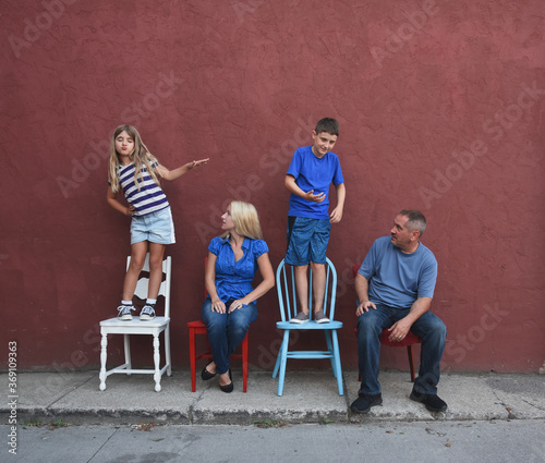 Family Looking at Funny Children Acting Out photo