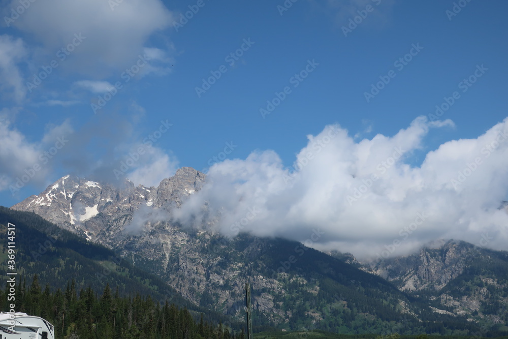 Clouds in front of mountain peaks