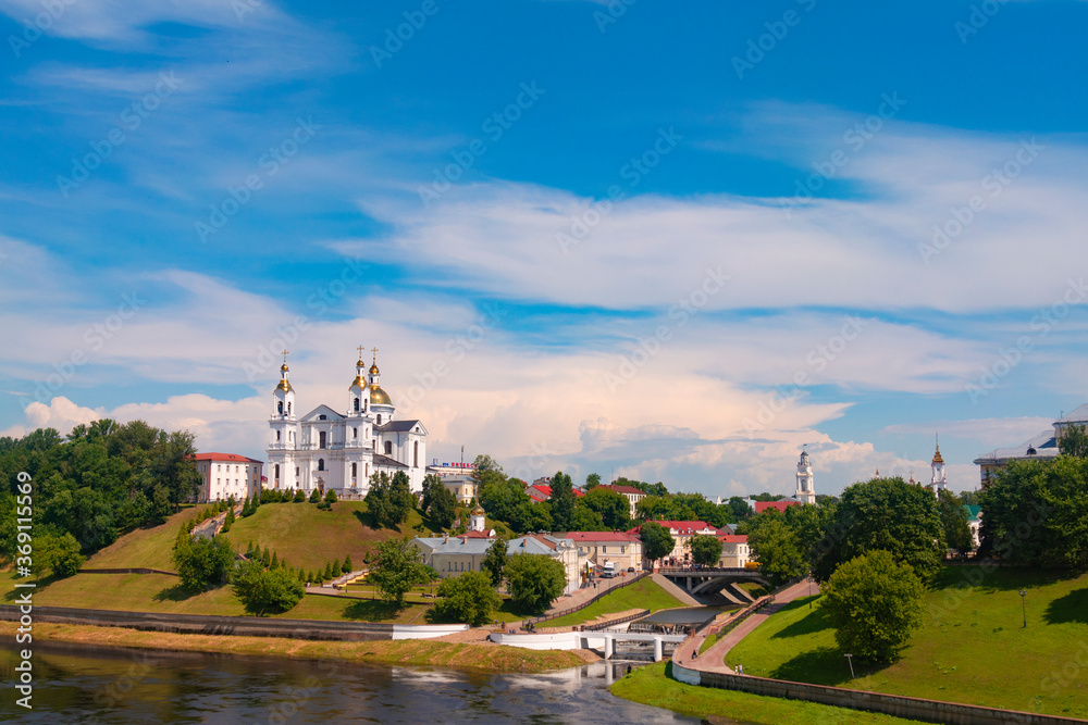 Vitebsk,Belarus - 21 July 2020 : Holy Assumption Cathedral of the Assumption on the hill and the Holy Spirit convent and Scenic view of beautiful blue sky with fluffy white clouds. Vitebsk, Belarus