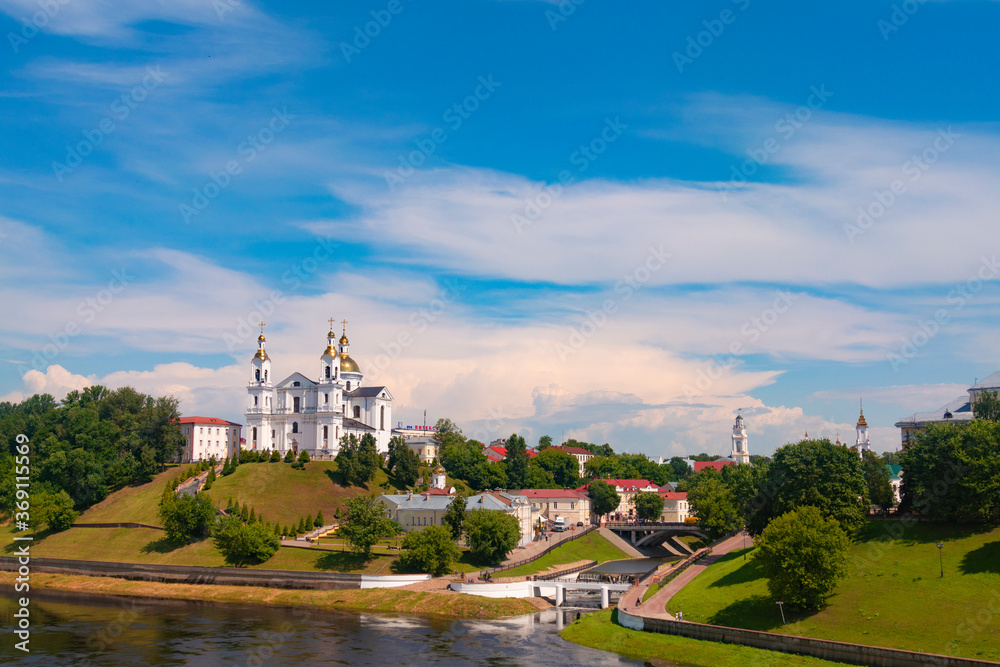 Vitebsk,Belarus - 21 July 2020 : Holy Assumption Cathedral of the Assumption on the hill and the Holy Spirit convent and Scenic view of beautiful blue sky with fluffy white clouds. Vitebsk, Belarus Vitebsk,Belarus - 21 July 2020 : Holy Assumption Cathedral of the Assumption on the hill and the Holy Spirit convent and Scenic view of beautiful blue sky with fluffy white clouds. Vitebsk, Belarus