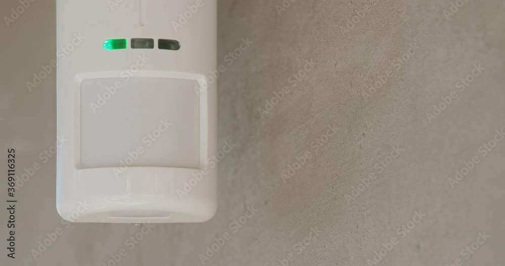 Security alarm sensor on the wall of the house.