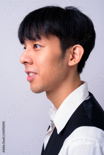 Portrait of happy young handsome Asian businessman