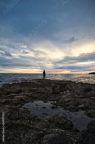 Silhouette of a man standing on the beach