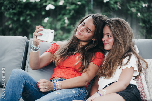 Sisters taking a selfie in the garden