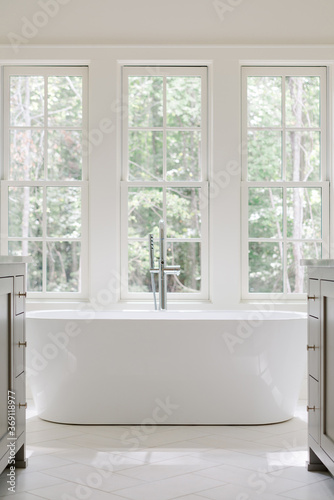 Modern bathtub in luxury custom-designed farmhouse