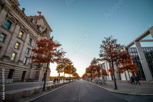 Trees at the street and the German parliament building (German Reichstag) at links and Paul Löbe Haus at right. photo
