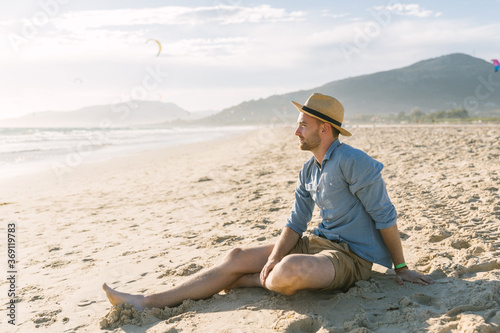 Young man enjoying at the beach photo