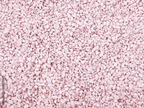 Texture background made of small stones toned pink. Used in gardening and landscape decoration.