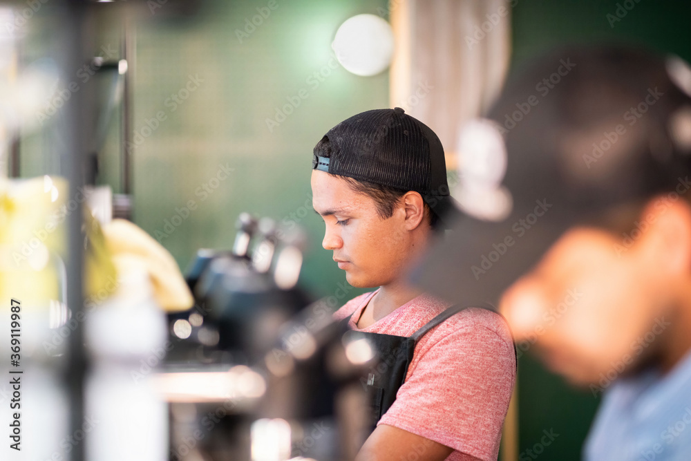 Serious bartender making drink in cafe Serious bartender making drink in cafe