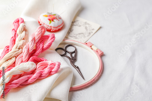 Embroidery set. Linen fabric, embroidery patterns, embroidery hoop, colorful threads and needls. photo